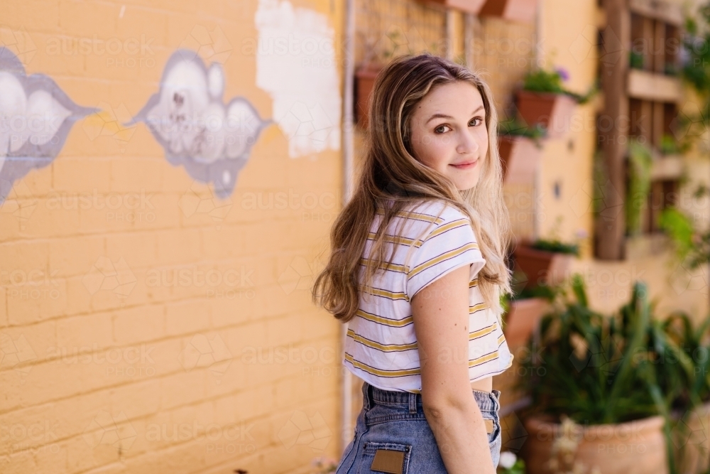 teen looking back over her shoulder - Australian Stock Image