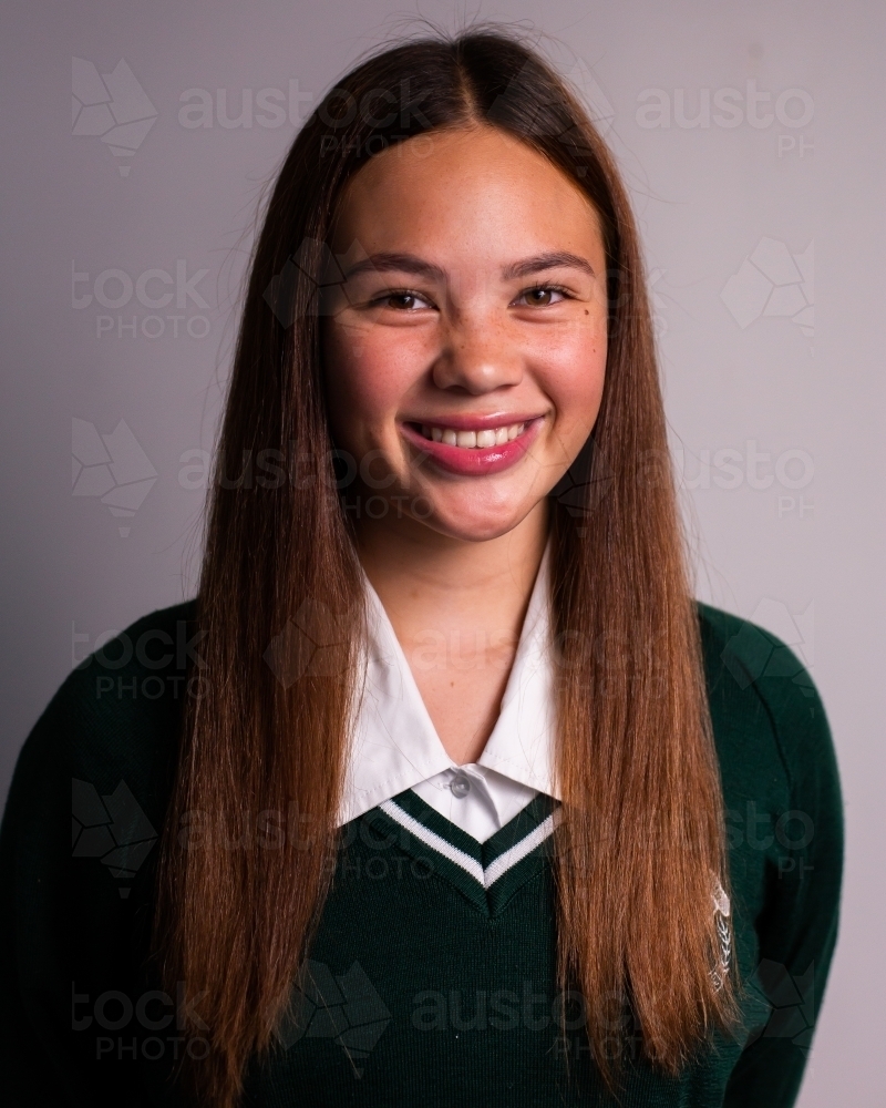 teen schoolgirl in school jumper with sleek hair - Australian Stock Image