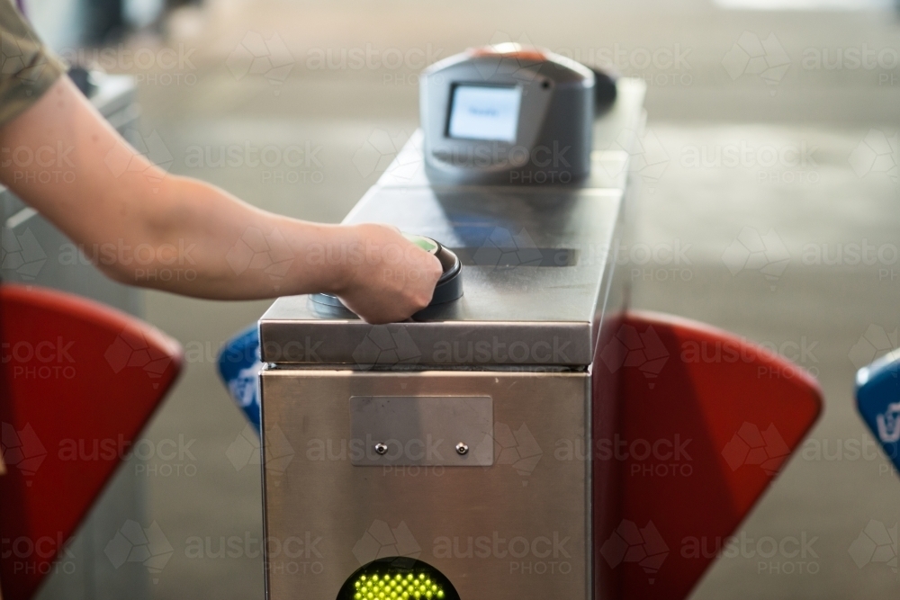 teen tapping on at the ferry terminal - Australian Stock Image