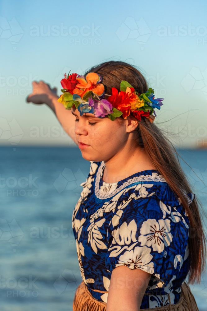 Teen Torres Strait Islander dancer performer girl in traditional floral dress and flower garland - Australian Stock Image