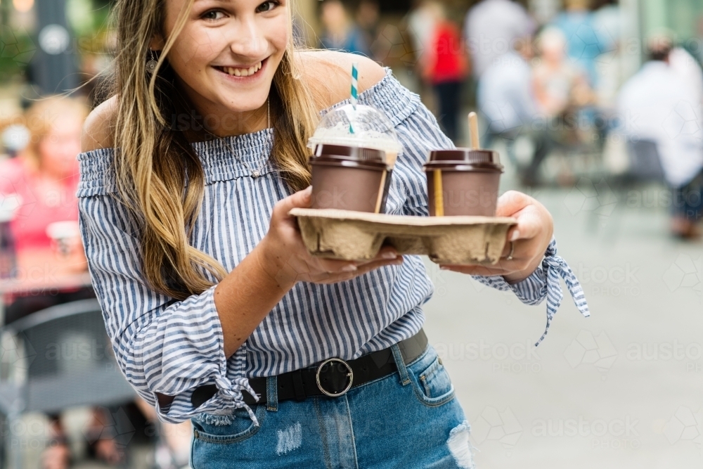 teen with takeaway coffees - Australian Stock Image