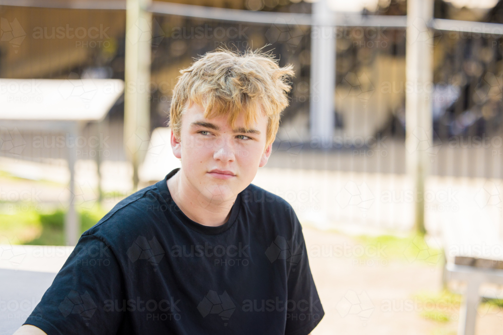 Teenage boy hanging out at outdoor go-kart track - Australian Stock Image