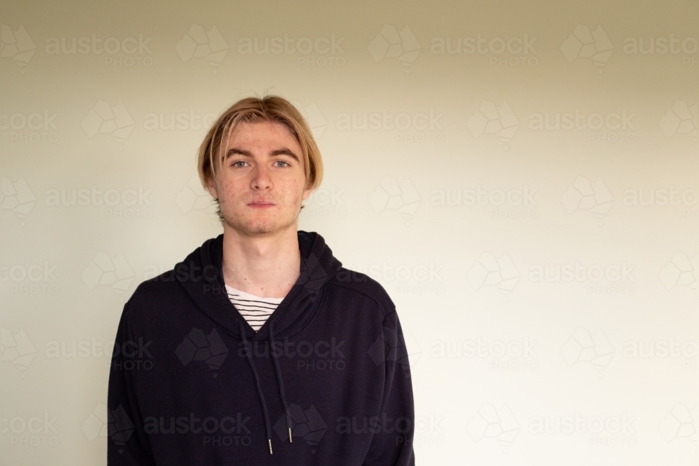 Teenage boy looking at camera head shot - Australian Stock Image