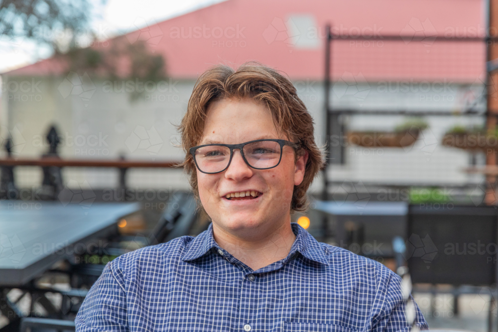 Teenage boy with glasses smiling - Australian Stock Image