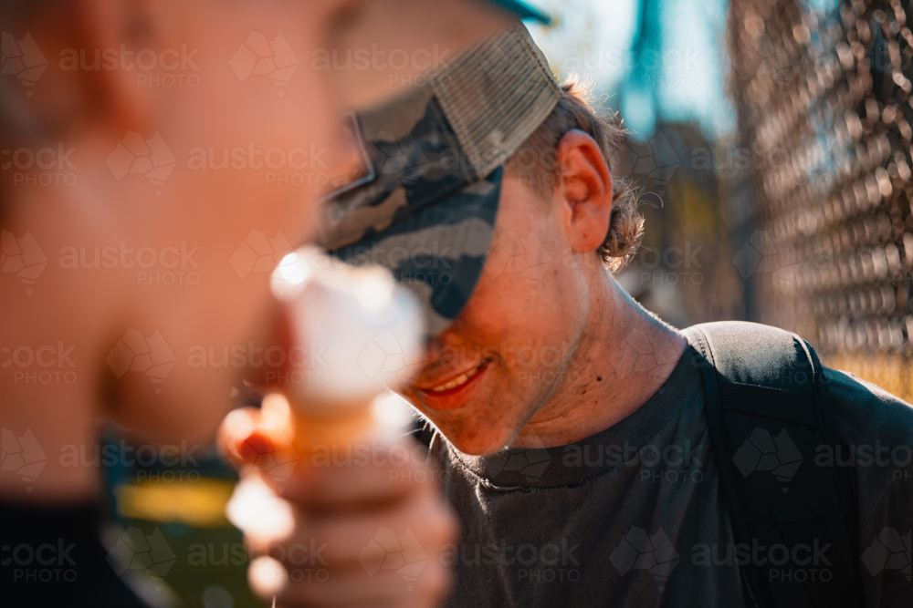 Teenage boys with dirty faces from soot watching burnout competition - Australian Stock Image