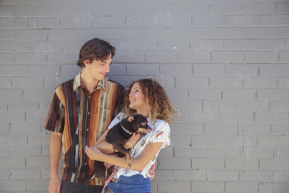 Teenage couple with a dog : Austockphoto Teenage couple with a dog - Australian Stock Image