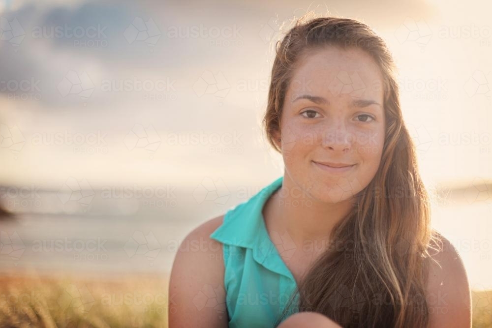 Teenage girl at the beach at sunset - Australian Stock Image