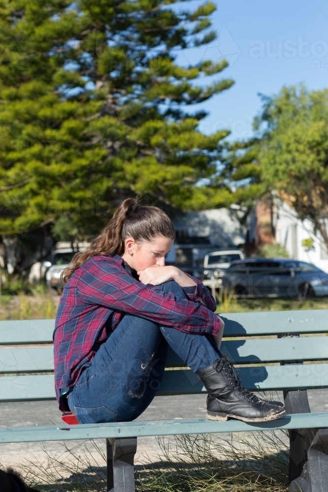 Teenage girl by herself in sombre mood - Australian Stock Image