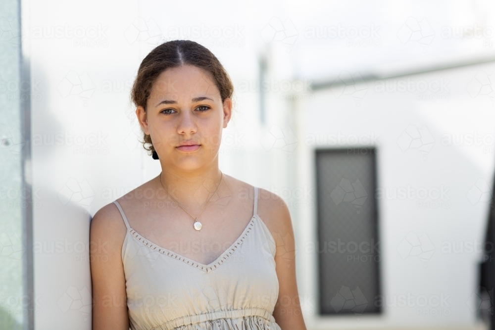 Teenage girl head and shoulders in relaxed pose - Australian Stock Image