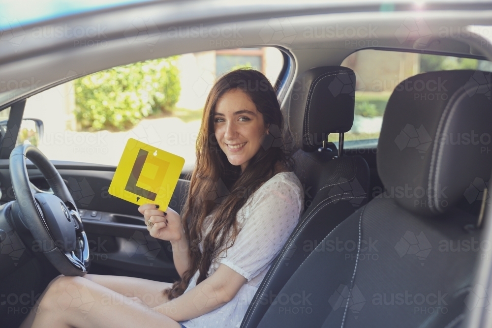 Teenage girl holding L plate : Austockphoto Teenage girl holding L plate - Australian Stock Image