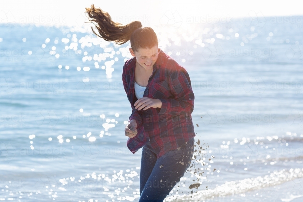 Teenage girl in sand fight on beach - Australian Stock Image