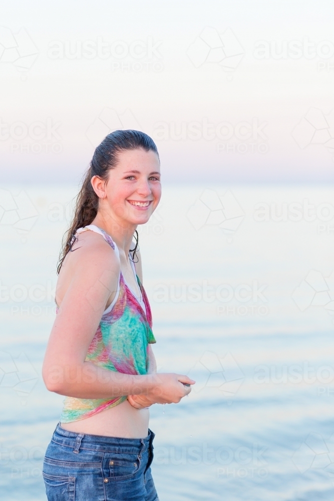 Image Of Teenage Girl On The Beach With Wet Clothes