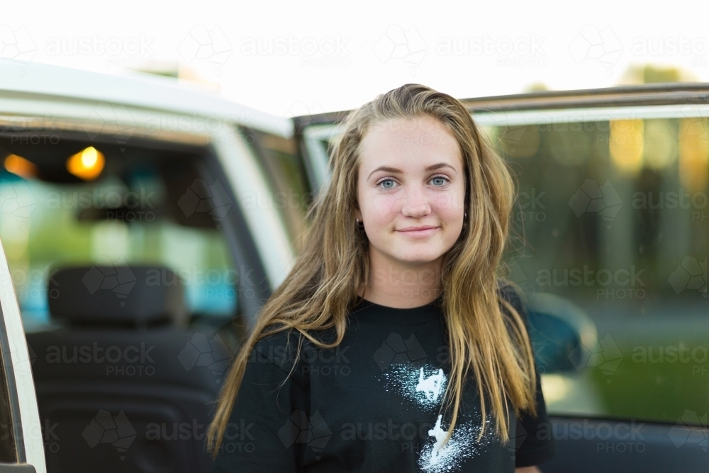Teenage girl with long hair looking at camera - Australian Stock Image