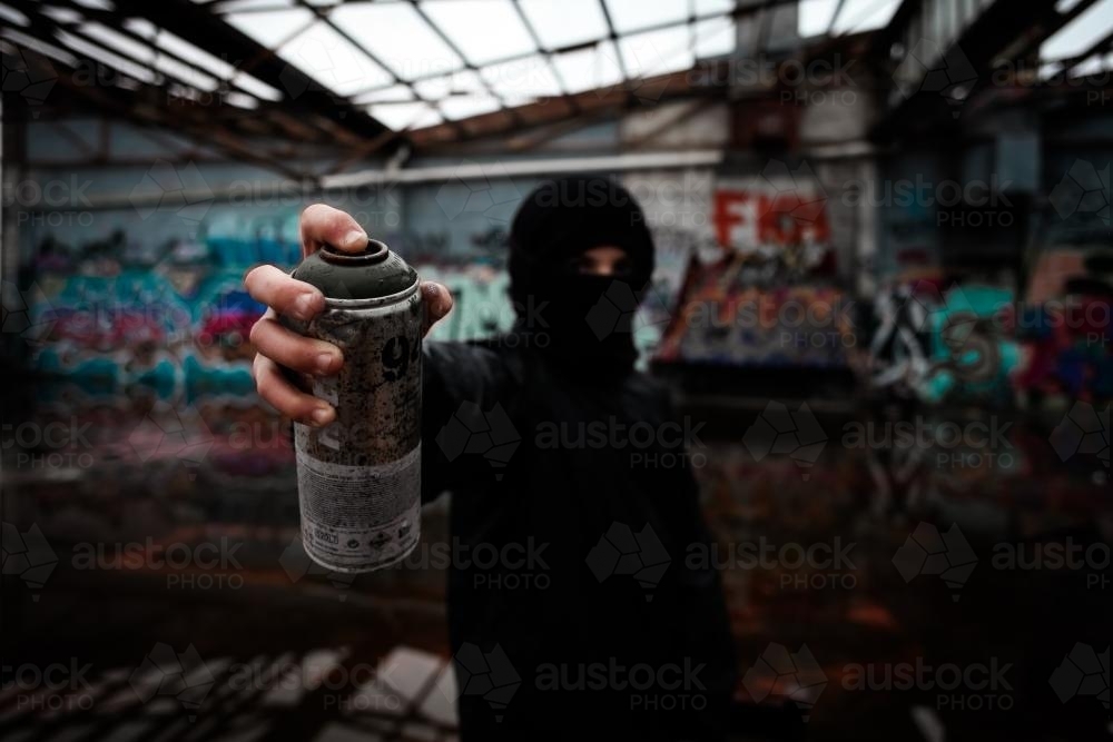 Teenage vandal holding a can of spray paint - Australian Stock Image