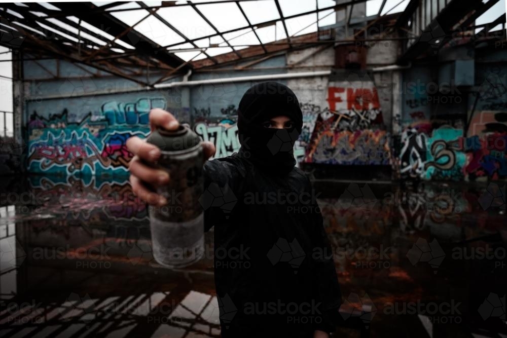 Teenage vandal with spray paint in his hand - Australian Stock Image