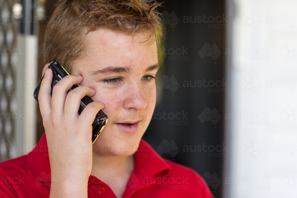Teenager talking on mobile phone - Australian Stock Image