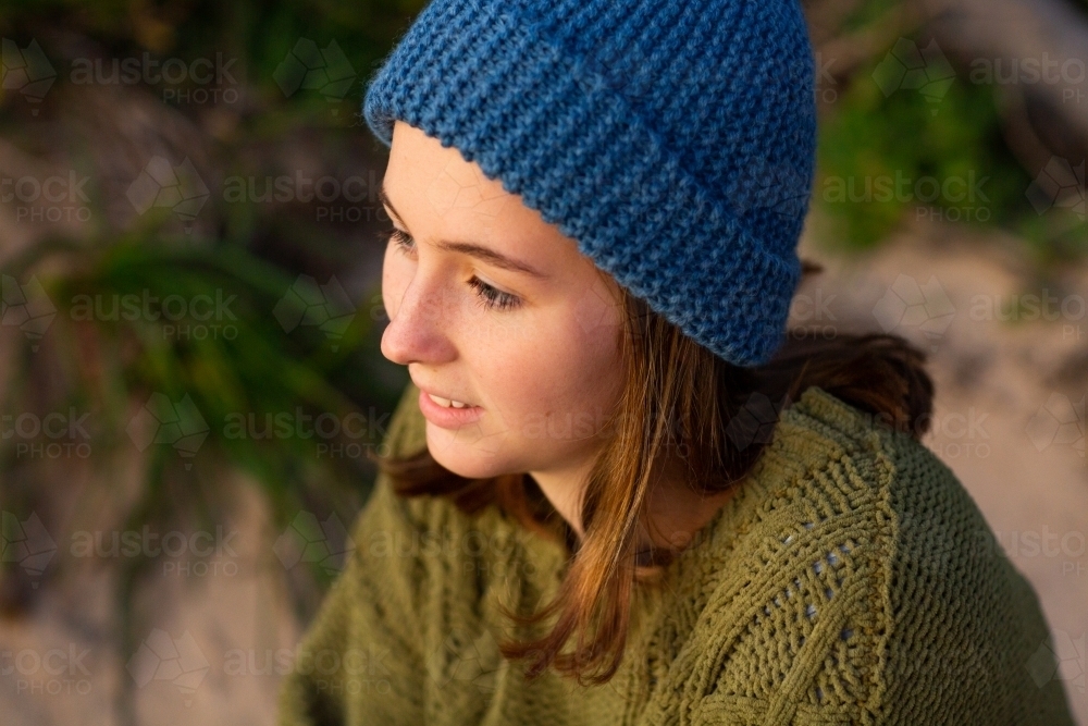 teenager wearing warm knitted clothing - Australian Stock Image