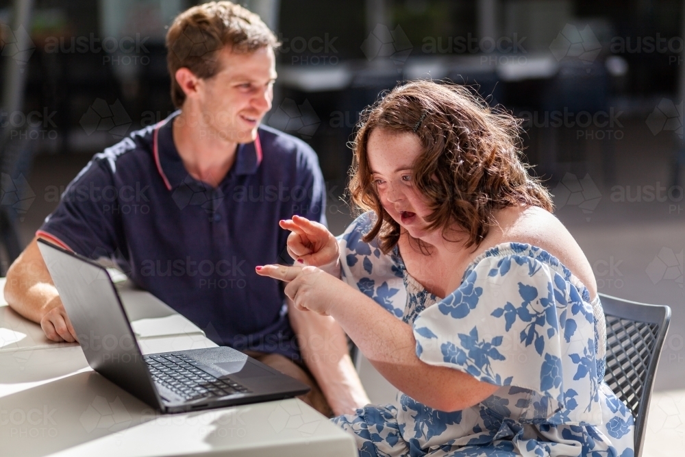 Teenager with down syndrome speaking with her hands using AUSLAN australian sign language - Australian Stock Image