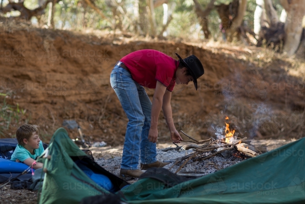 Image of Teenagers camping with with swags Austockphoto