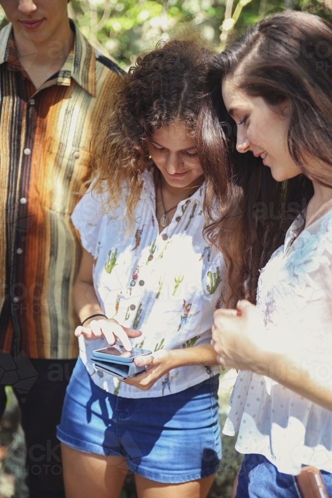teenagers using mobile - Australian Stock Image