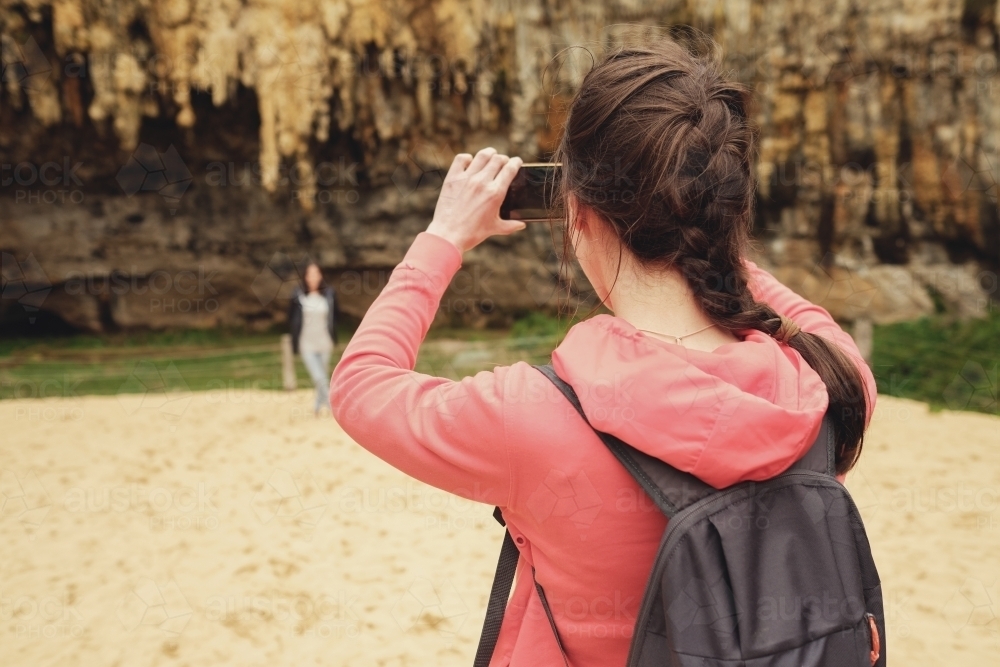 Teenagers using mobile taking pictures - Australian Stock Image