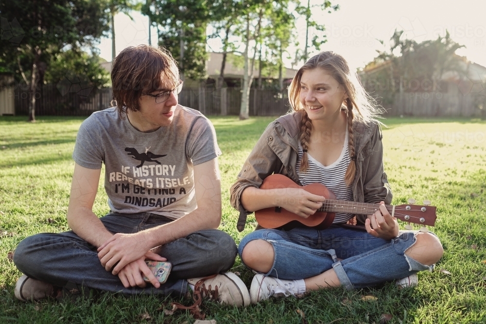 Teenagers with ukulele in the park - Australian Stock Image