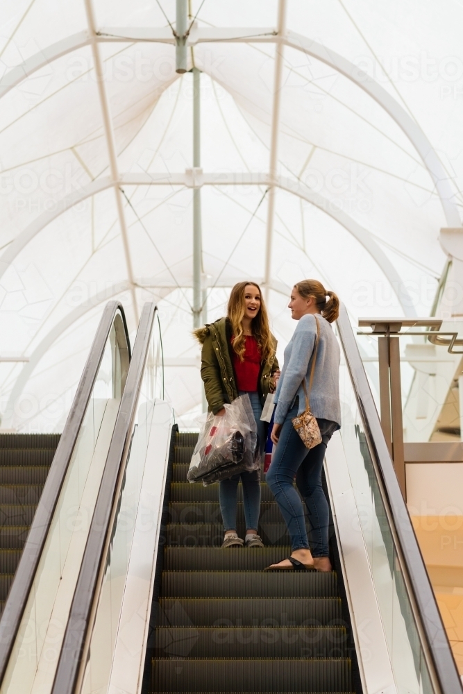 teens on the escalator at the shopping mall - Australian Stock Image