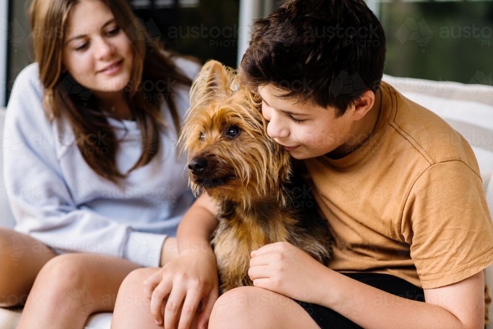 teens with their dog, australian terrier - Australian Stock Image