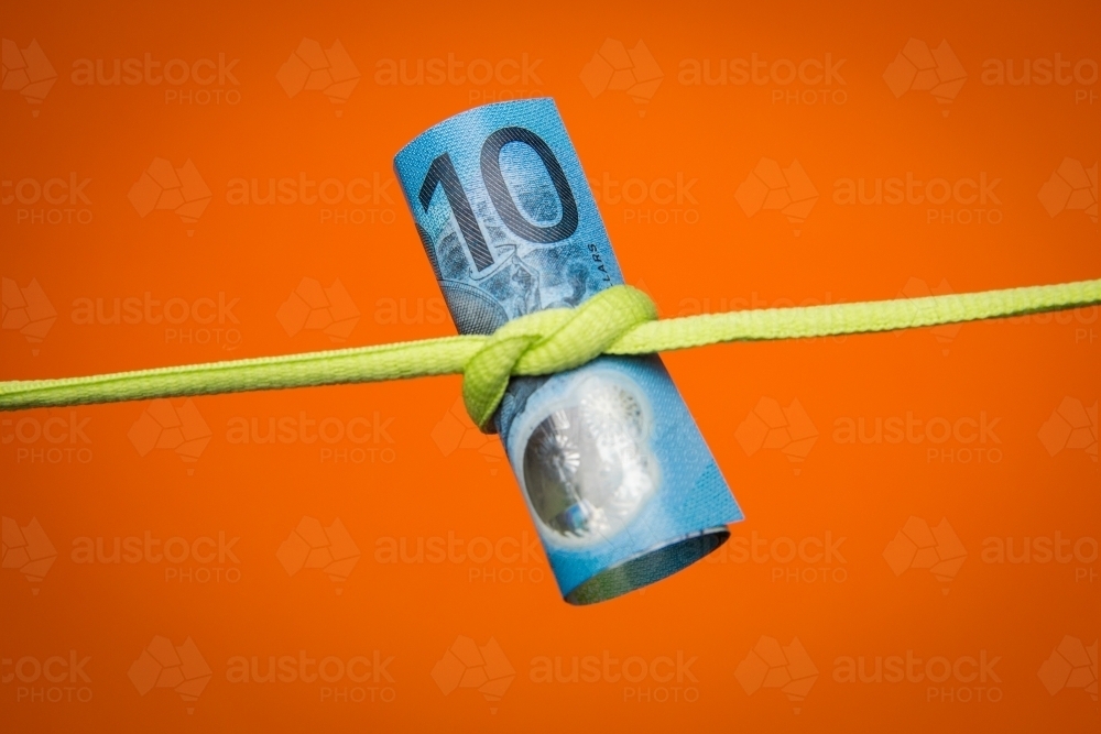 Ten Dollars Tied Up on an Orange Background - Australian Stock Image