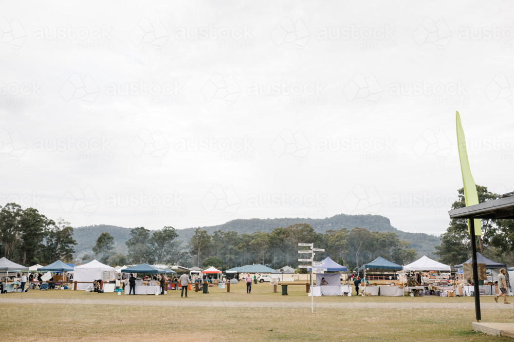 Tent stalls set up in public park for festival event - Australian Stock Image