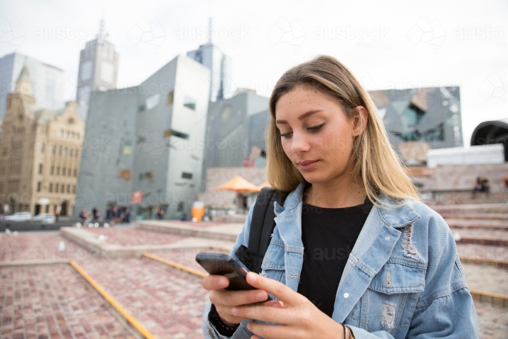 Texting in Federation Square - Australian Stock Image