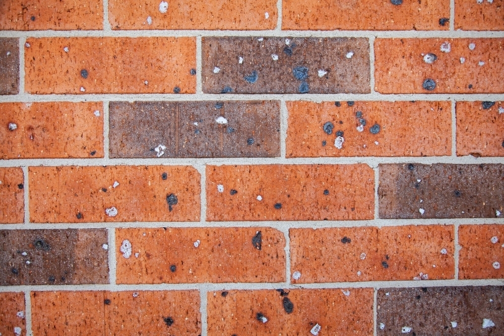 Texture of red and brown brick of house wall - Australian Stock Image