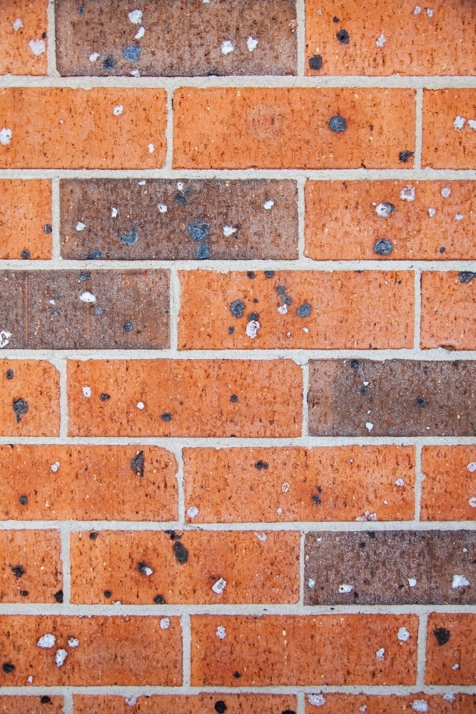 Texture of red and brown brick of house wall - Australian Stock Image