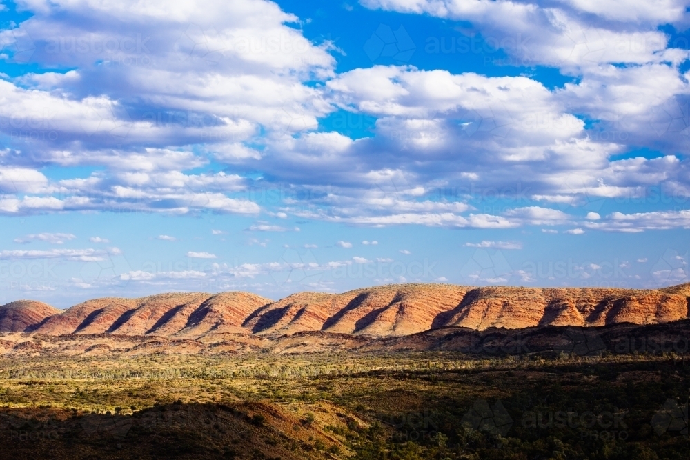 Textured hills and sky of the West MacDonnell Ranges in central Australia. - Australian Stock Image