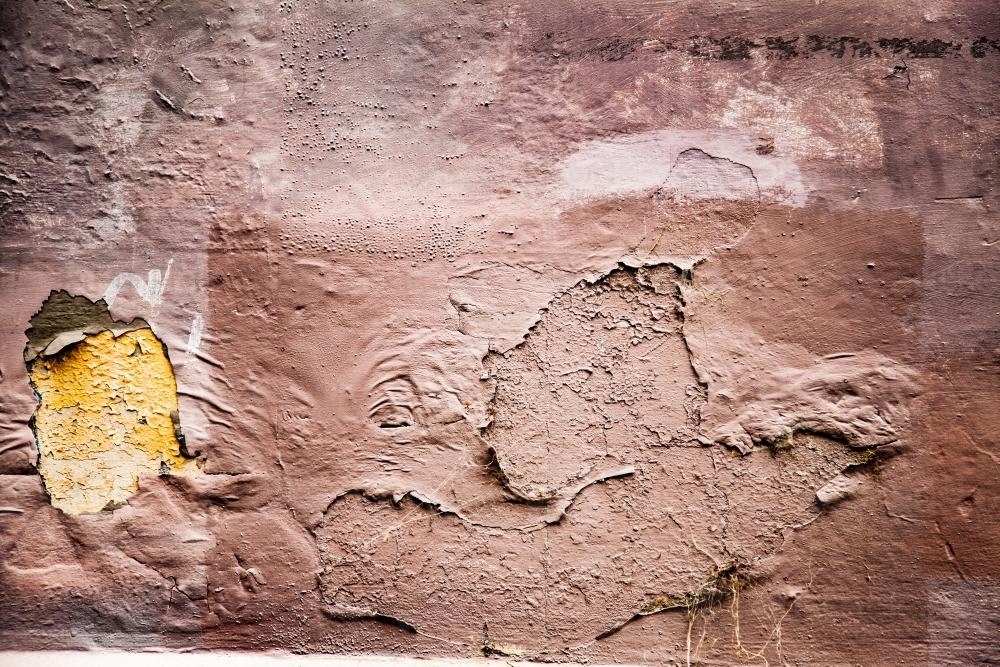 Textures of peeling paint on a dirty pink wall - Australian Stock Image