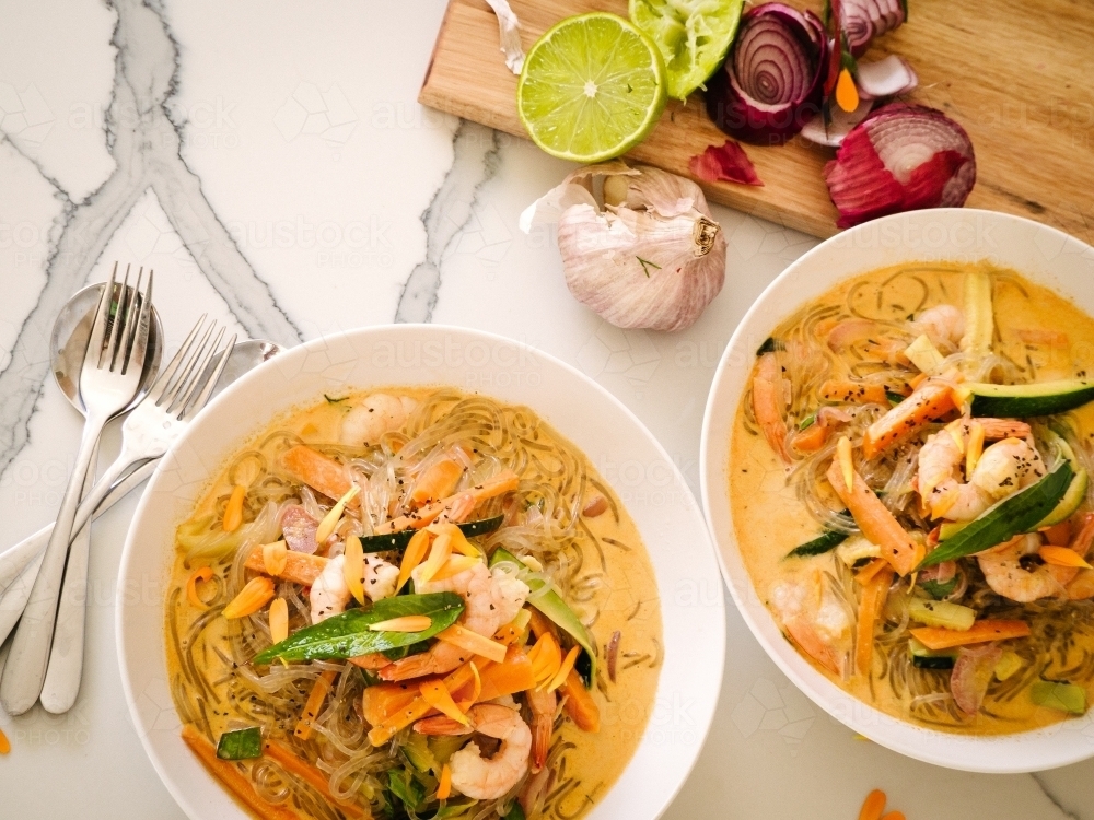 Thai red prawn noodles served up in bowls ready to eat - Australian Stock Image