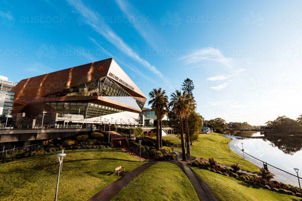 The Adelaide Convention Centre, late afternoon with bright sunshine and water reflection from river - Australian Stock Image