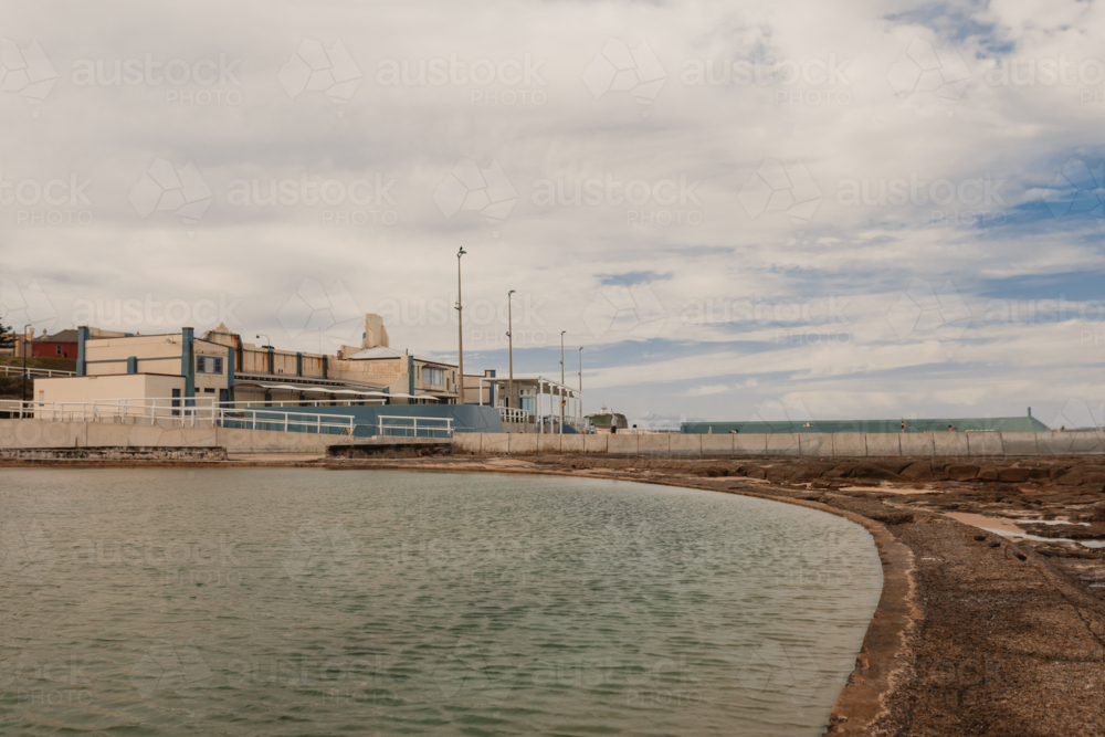 The Canoe Pool beside Newcastle Ocean Baths on cloudy day - Australian Stock Image