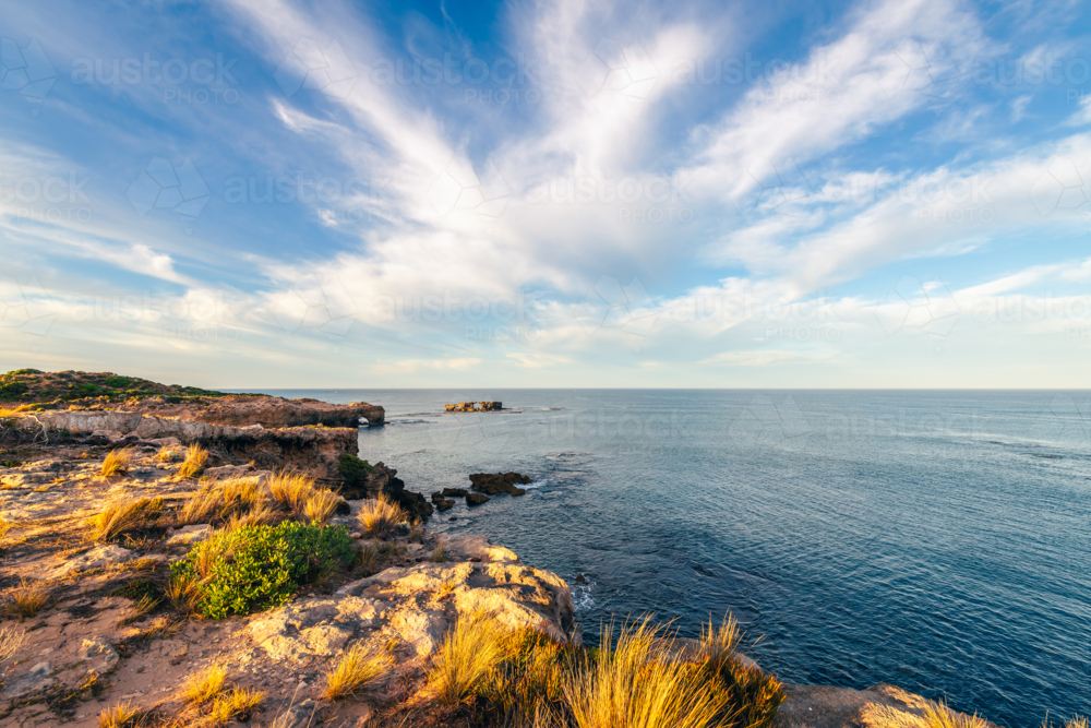 The Doorway Rock during sunrise and calm waters. - Australian Stock Image