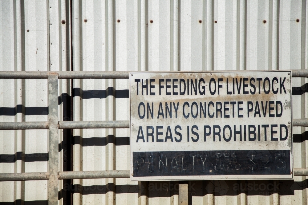 The feeding of livestock on any concrete paved areas is prohibited sign at the sale yards - Australian Stock Image