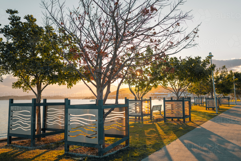 The footpath through Belmont Lions park on the shoreline of Lake Macquarie at sunset - Australian Stock Image