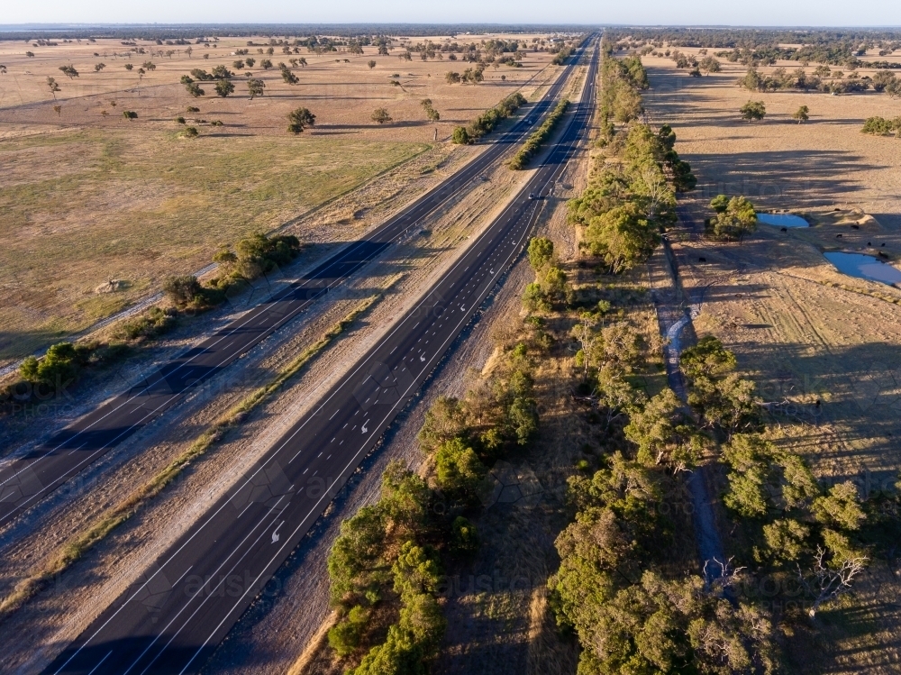 The Forrest Highway cutting through farmland in the Peel Region - Australian Stock Image