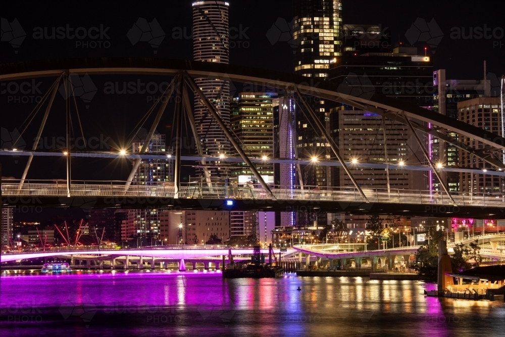 The Goodwill Bridge and Brisbane city at night with light reflecting over the water - Australian Stock Image