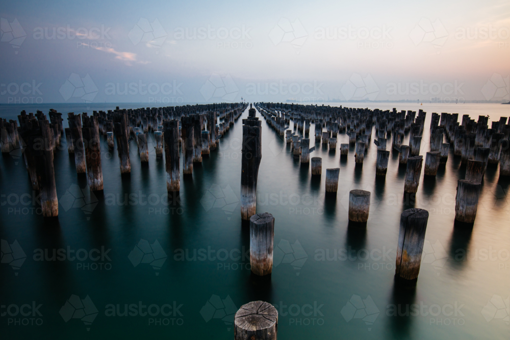 The historic Princes Pier featuring many disused pylons on a hot summer's day - Australian Stock Image