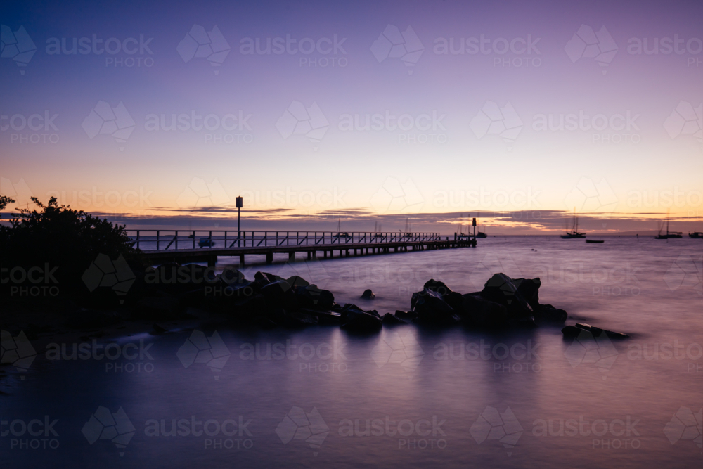 The iconic Cameron's Bight Jetty on a cool winter's morning at sunrise on the Mornington Peninsula - Australian Stock Image