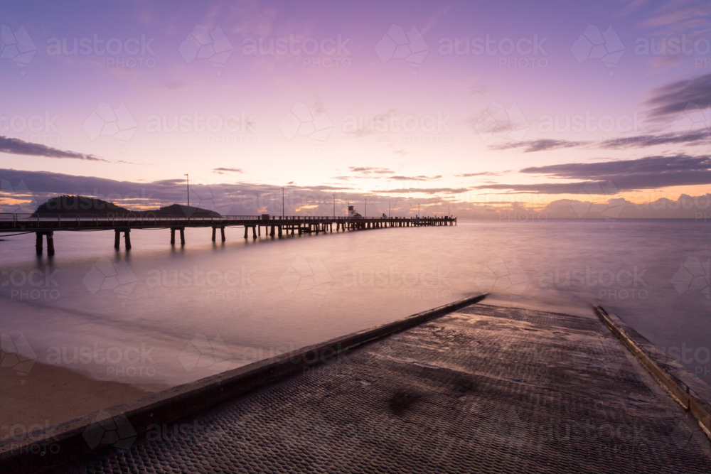 The iconic Palm Cove jetty and boat ramp at sunrise on a winter's morning. - Australian Stock Image