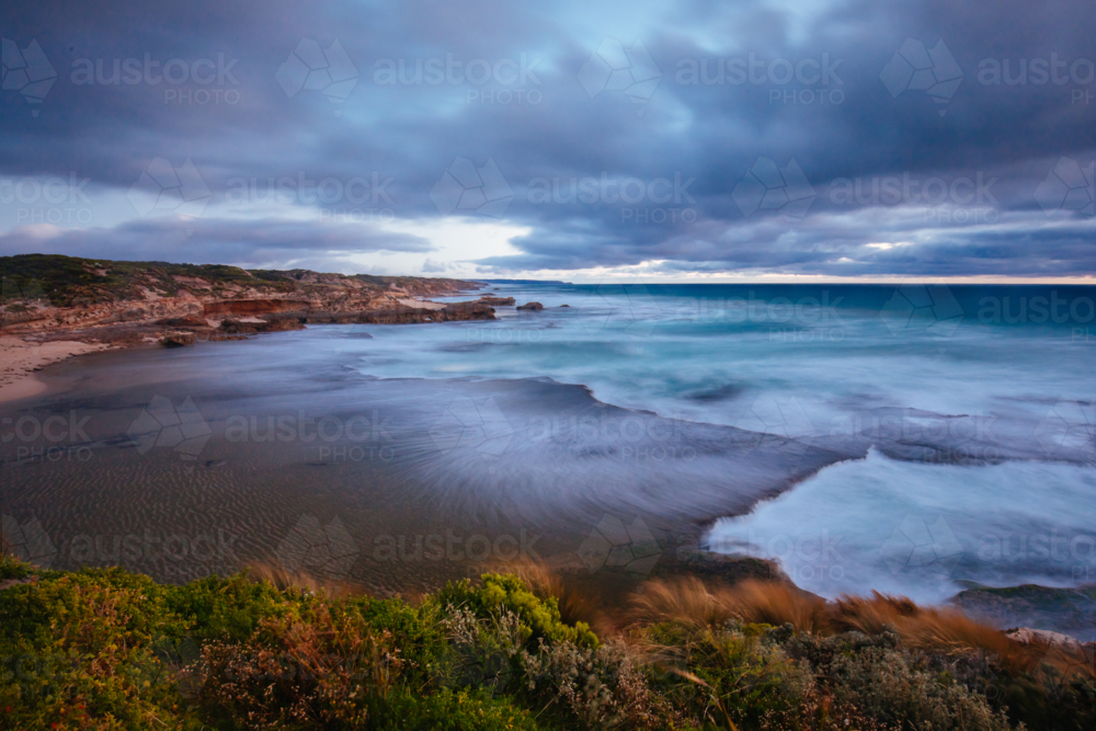 The idyllic Pearses Beach and headland around Pirates Bay Cove on a hot summer's evening - Australian Stock Image