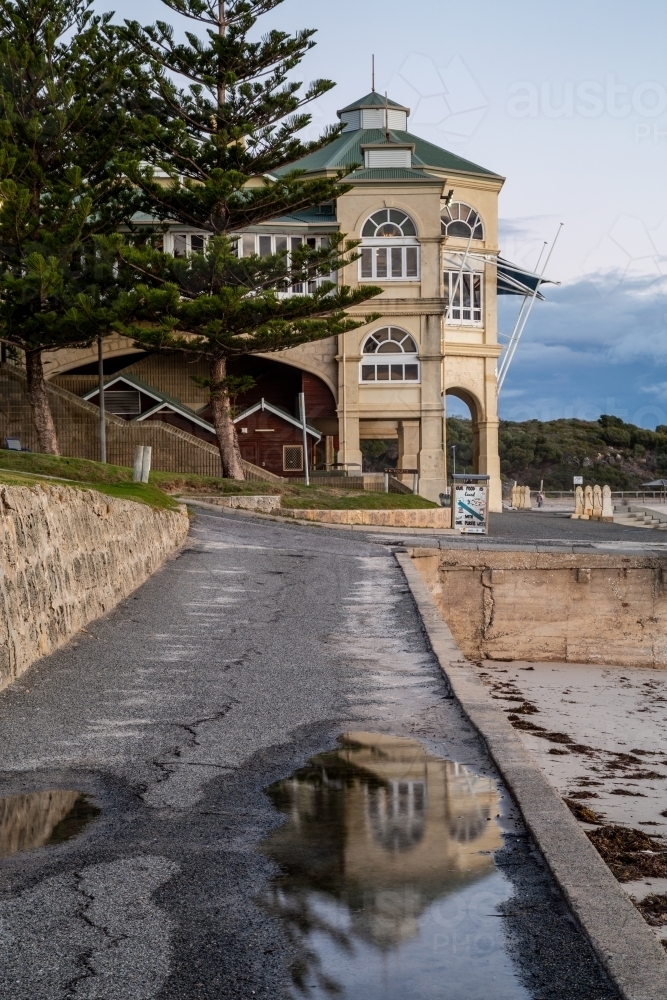 The Indiana Tea House of Cottesloe Beach, reflected in a rain puddle. - Australian Stock Image