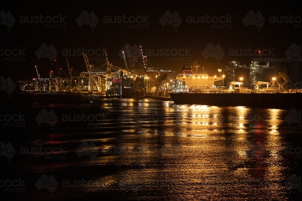 The industrial lighting emitted from The Port of Brisbane operating at night. : Austockphoto The industrial lighting emitted from The Port of Brisbane operating at night. - Australian Stock Image