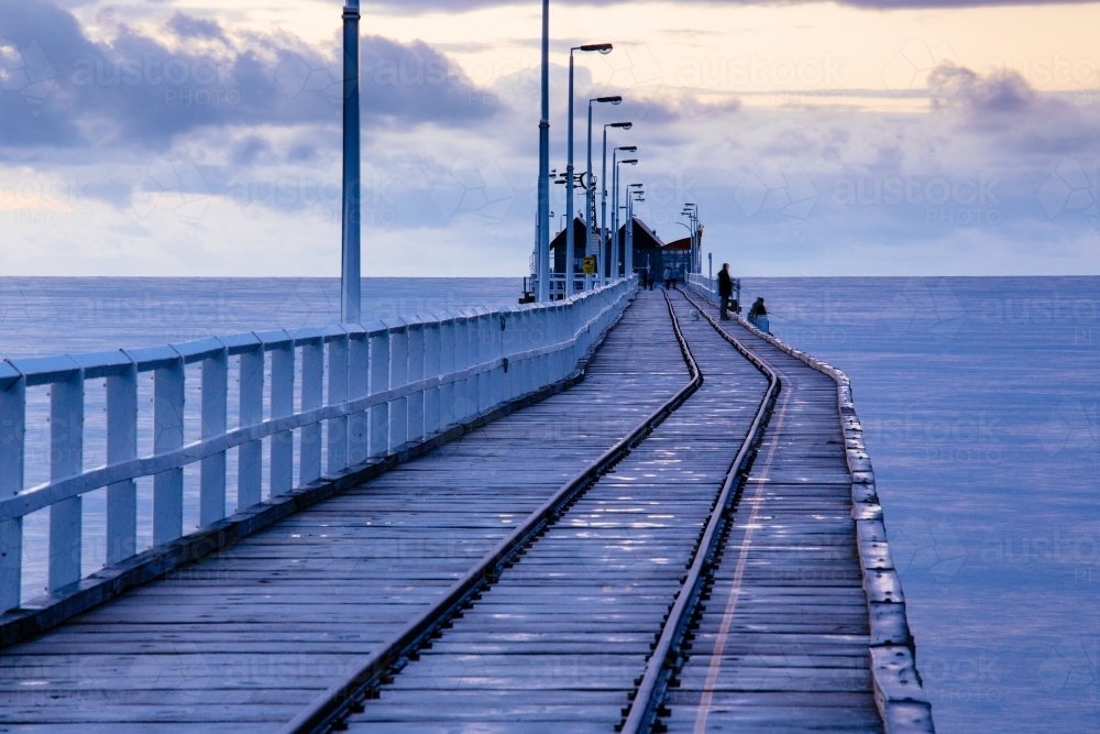 The last section of the Busselton Jetty with its rail line and timber structure. - Australian Stock Image